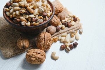 Mixed nuts on wood floor. Organic and fresh nuts. Copy space