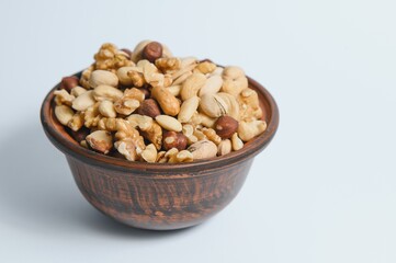 Mixed nuts on a plate. White background
