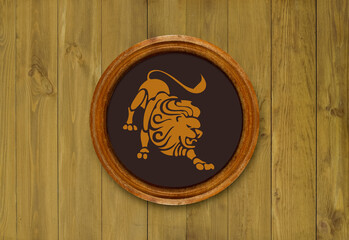 The sign of the zodiac Leo in a round frame on the wall of the boards