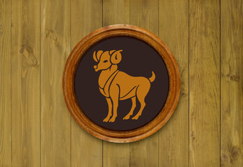 The sign of the zodiac Aries in a round frame on the wall of the boards