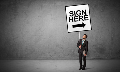 business person holding a traffic sign