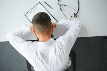 Fototapeta premium Portrait of exhausted tired young arab male doctor after hard day at work