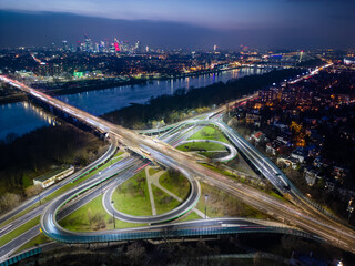 Aerial view of Lazienkowski Bridge, large road intersection and distant Warsaw city center, Poland