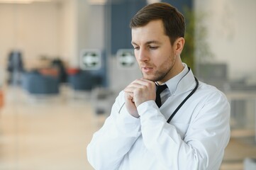 Praying for a successful operation. Cropped shot of a handsome male doctor praying.