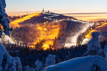 A high angle view to Ruka ski resort slopes on a late winter evening near Kuusamo, Northern Finland - obrazy, fototapety, plakaty