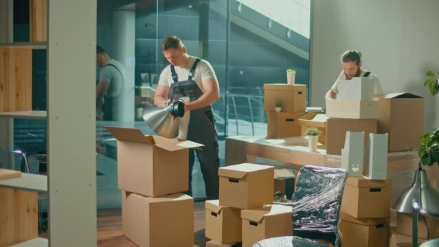 Workers of Moving Company With Uniforms Carefully Packing and Carrying Boxes. Shipping and Packaging Business Occupation Service Company. Preparation for a Long Trip, Transportation of Things