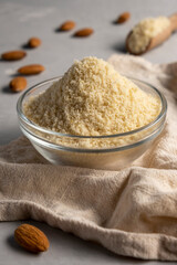 Almond flour and almonds in bowls. Gluten free food concept.