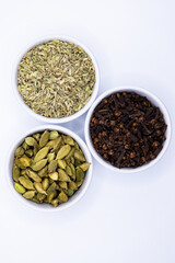 Fennel seeds, Cardamom, and Cloves in bowls