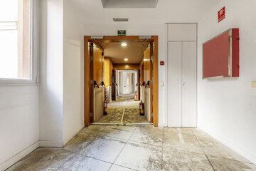 Long corridor of a large site to dedicate it to offices with raw material to make a reform