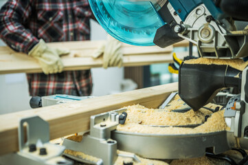 Worker Cut Wood Beams To Size Using a Saw Woodwork Project