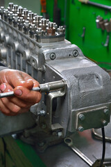 car fuel pump repair, truck fuel pump housing on workbench in service, repair tools and workbench...
