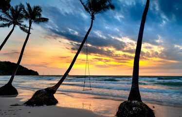 Dawn on a deserted beach with beautiful leaning coconut trees in Phu Quoc island, Kien Giang province, Vietnam