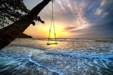 Dawn on a deserted beach with beautiful leaning coconut trees in Phu Quoc island, Kien Giang province, Vietnam