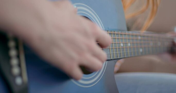 girl preparing for performance, consert, close up cropped slow motion, woman have guitar lessons. self-taught genius
