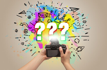Close-up of a hand holding digital camera with abstract drawing concept
