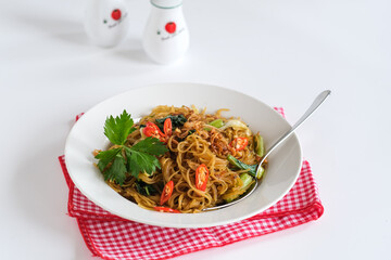 bihun goreng or stir fried rice vermicelli with vegetables and chili. a  food with delicious, spicy and sweet taste 