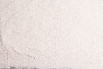 Wheat flour, barley, cooking, bread, and cookies are arranged on the table in a rustic kitchen, top view.