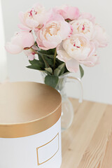 Romantic peonies on a light background. Feminine bouquet for a wedding or birthday.