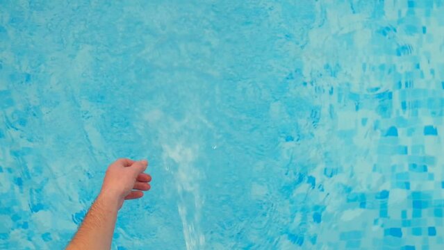 Pool water filtration.hand throws a cleaning filter with chlorine tablets into the blue water of the pool.slow motion. Swimming pool Filter.Blue water filter.Swimming pool cleaning. High quality 4k