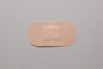 Contraceptive patch on light grey background, top view