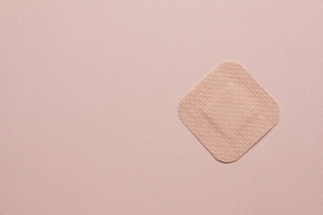 Contraceptive patch on pink background, top view. Space for text