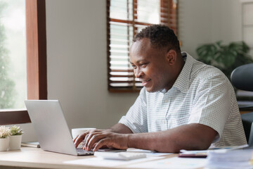 American African Businessman research and analysis with financial graph at office. Strategy, chart, finance report concept