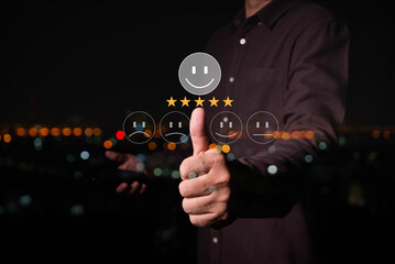 businessman hand touch on virtual screen at happy Smiley face to give satisfaction in service. rating very impressed , Customer service and Satisfaction concept