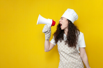 girl chef in apron and baking gloves holds megaphone and announces information on yellow background