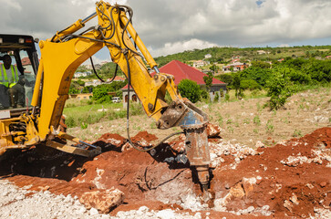 Fototapeta premium An Industrial Jackhammer Breaking Stone