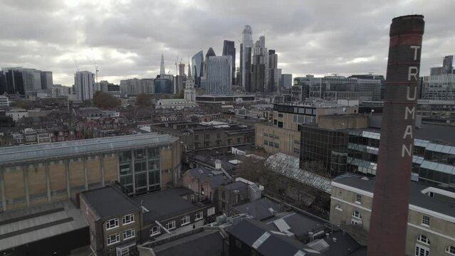  Christ Church Spitalfields in urban borough. Fly around old religious structure contrasting with modern skyscrapers in background. London, UK