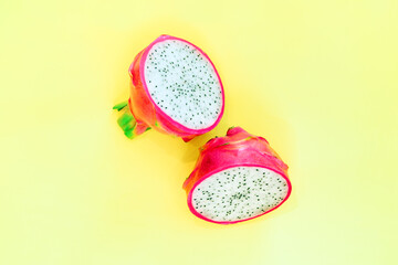 Fresh half dragon fruit or pitahaya (pitaya) on yellow background, top view