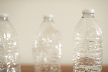 Close up Photo of three used crumpled waste plastic water bottles with plastic caps concept 
