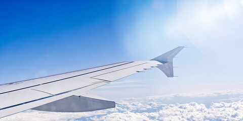 Wing aircraft in altitude during flight. clear sky in sunny day. travel concept