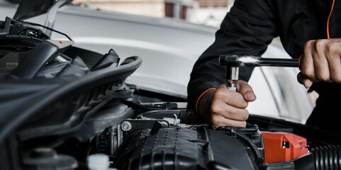 Mechanic fixing a car at home. Repair and service.