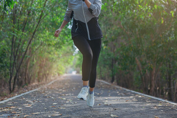 Fototapeta premium Young woman running sprinting on road. Fit runner fitness runner during outdoor workout.