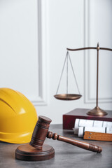 Construction and land law concepts. Judge gavel, scales of justice, protective helmet with drawings...