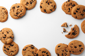 Frame made of many delicious chocolate chip cookies on white background, flat lay. Space for text