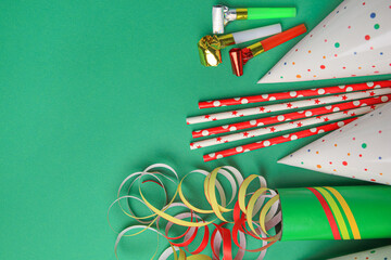 Many different party items on green background, flat lay. Space for text