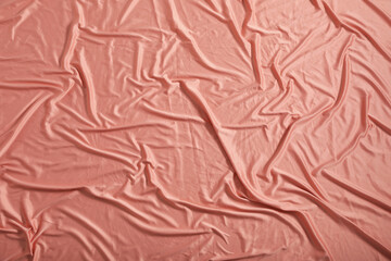Crumpled coral fabric as background, closeup view