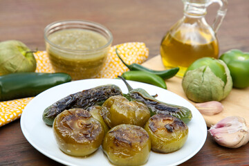 Different ingredients and tasty salsa sauce on wooden table