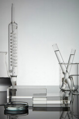 Test tube, petri dish filled with water and laboratory glassware displayed with rectangle...