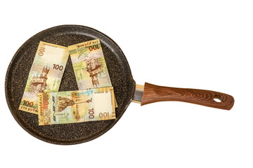 New pancake pan with stone nonstick coating is decorated with three new russian commemorative banknotes 100 rubles. 