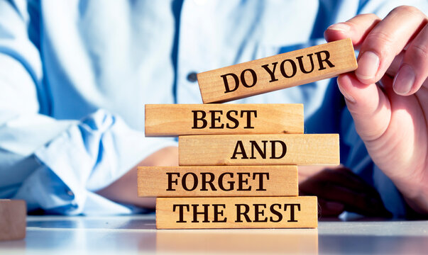 Close up on businessman holding a wooden block with "Do Your Best and Forget the Rest" message