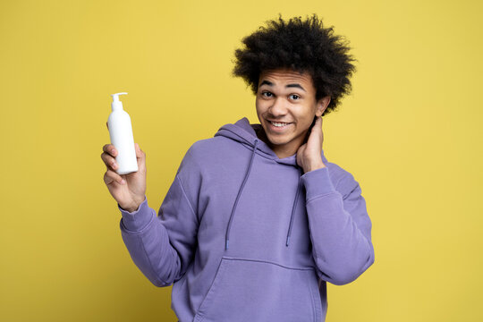 Smiling Man Holding White Bottle Of Moisturising Nourishing Anti Dandruff Shampoo