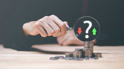 man holding a magnifying glass ,Financial planning and investment ,Analysis of company financial...