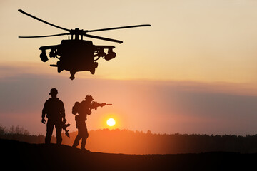 Fototapeta na wymiar Silhouettes of helicopter and soldiers on background of sunset. Greeting card for Veterans Day, Memorial Day, Air Force Day. USA celebration.