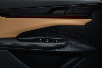 Side door buttons: window, mirror adjustment buttons, door lock. Car inside.