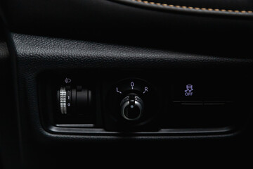 close-up of black of side mirror buttons on car panel, no trade marks