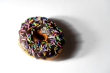 Colourful donuts on white background. Top view