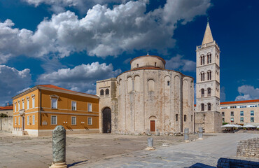Zadar, Croatia - The Roman Forum of the old city of Zadar with the Church of St. Donatus and the bell tower of the Cathedral of St. Anastasia taken on a bright summer day with blue sky and clouds